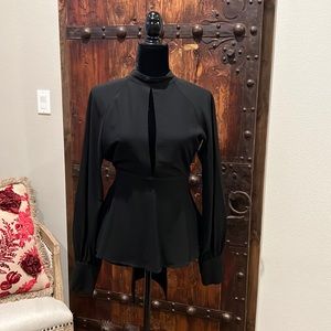 Dressy black Top. Most likely from Revolve retail store.